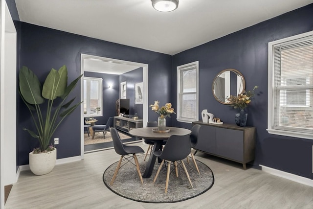 dining space with light hardwood / wood-style floors