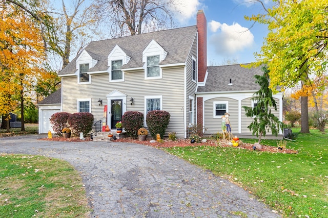 cape cod house with a garage and a front yard