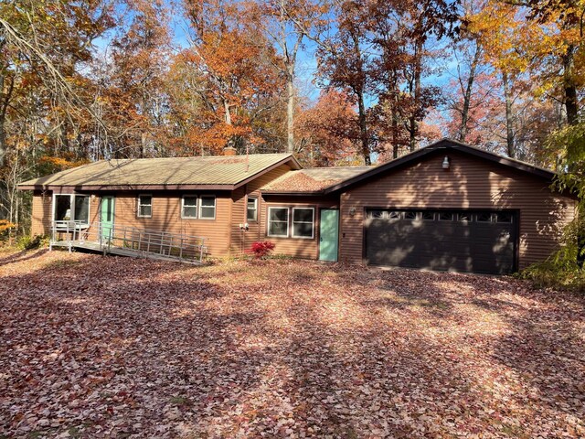 7468 W 6 1/2 Mile Rd, Irons, MI 49644 - view of front of house featuring an attached garage