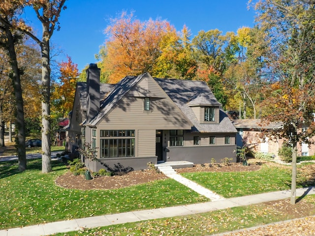 view of front of property featuring a front yard and a chimney