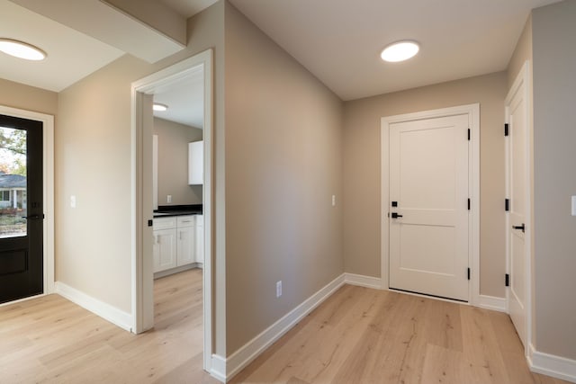 entrance foyer with light wood-type flooring and baseboards