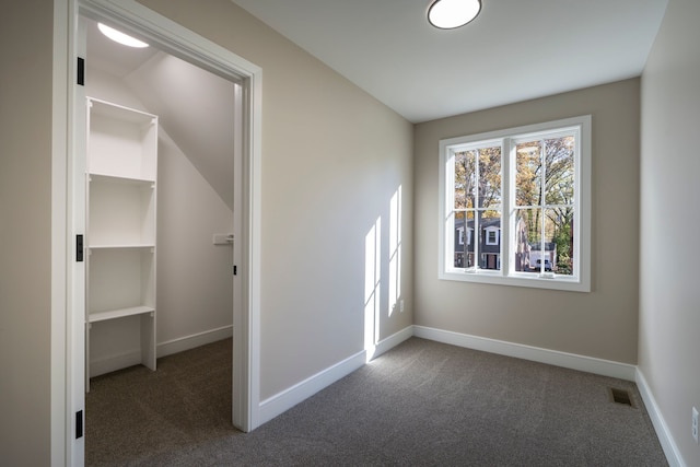 interior space featuring visible vents, carpet flooring, and baseboards