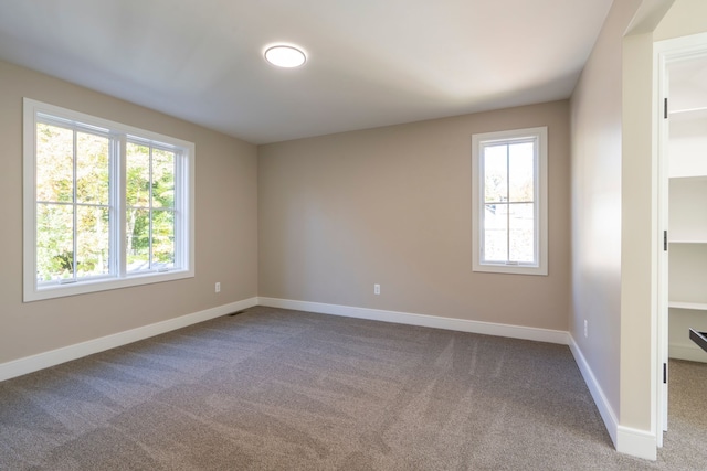 empty room with carpet flooring and baseboards