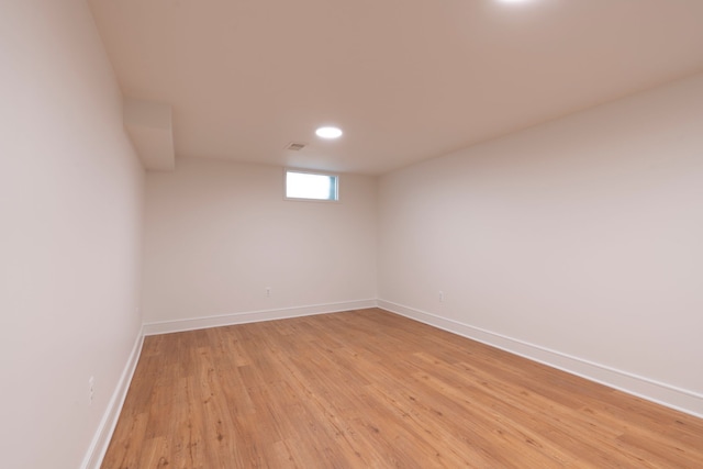 spare room with recessed lighting, baseboards, and light wood finished floors