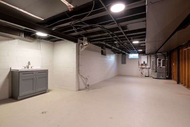 basement with electric panel, heating unit, and a sink