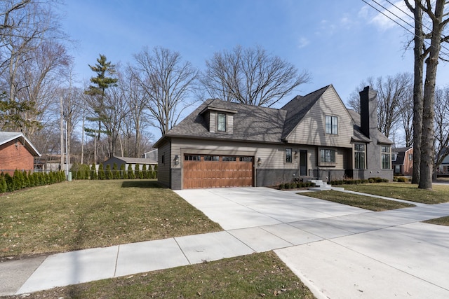 view of front of house featuring a chimney, a garage, concrete driveway, and a front yard