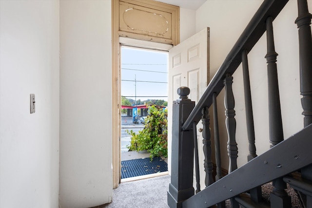 view of carpeted foyer entrance