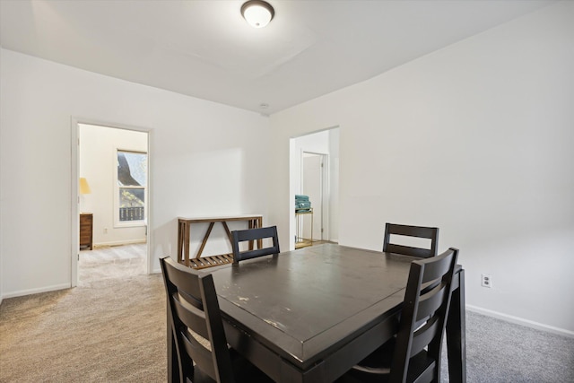 dining space with carpet flooring