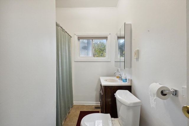 bathroom featuring vanity, ornamental molding, and toilet