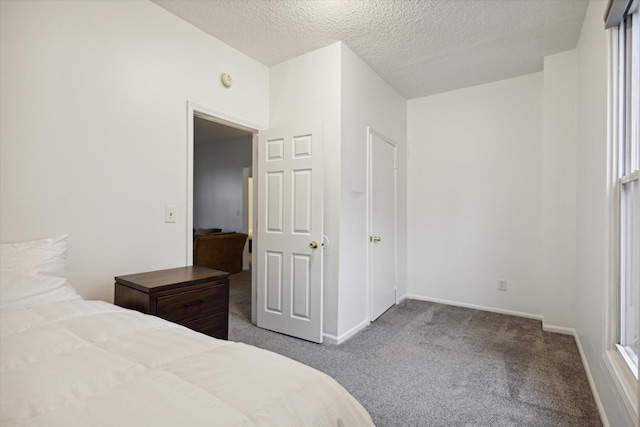 carpeted bedroom featuring a textured ceiling