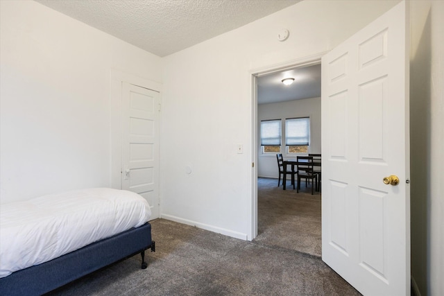 carpeted bedroom featuring a textured ceiling