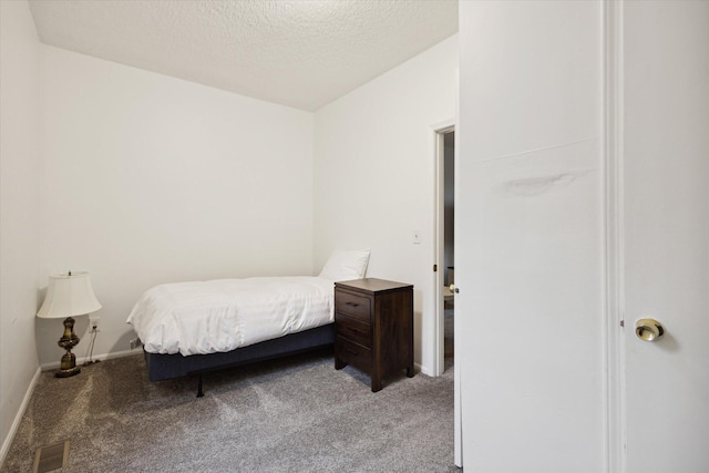 carpeted bedroom featuring a textured ceiling