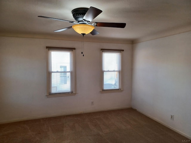 carpeted empty room with plenty of natural light and ceiling fan