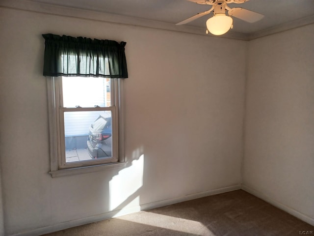 carpeted empty room featuring ceiling fan