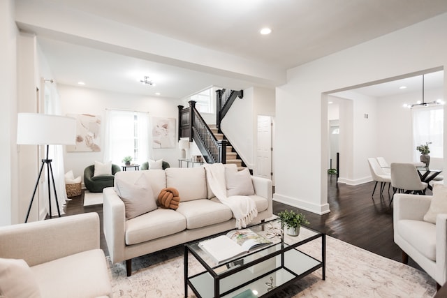 living room with hardwood / wood-style floors and a chandelier