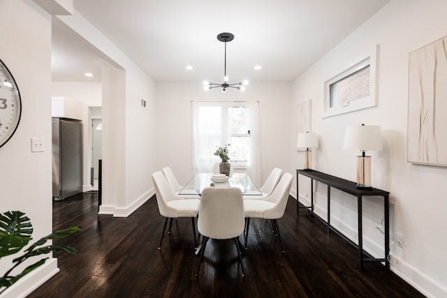 dining area featuring dark hardwood / wood-style floors and a notable chandelier