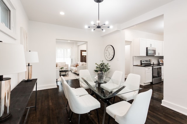 dining room featuring dark hardwood / wood-style flooring and a chandelier