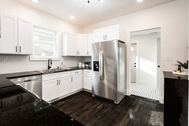 kitchen with dark hardwood / wood-style flooring, sink, stainless steel appliances, and white cabinetry