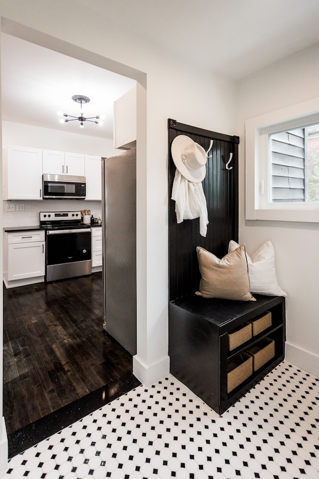 mudroom featuring dark tile patterned flooring