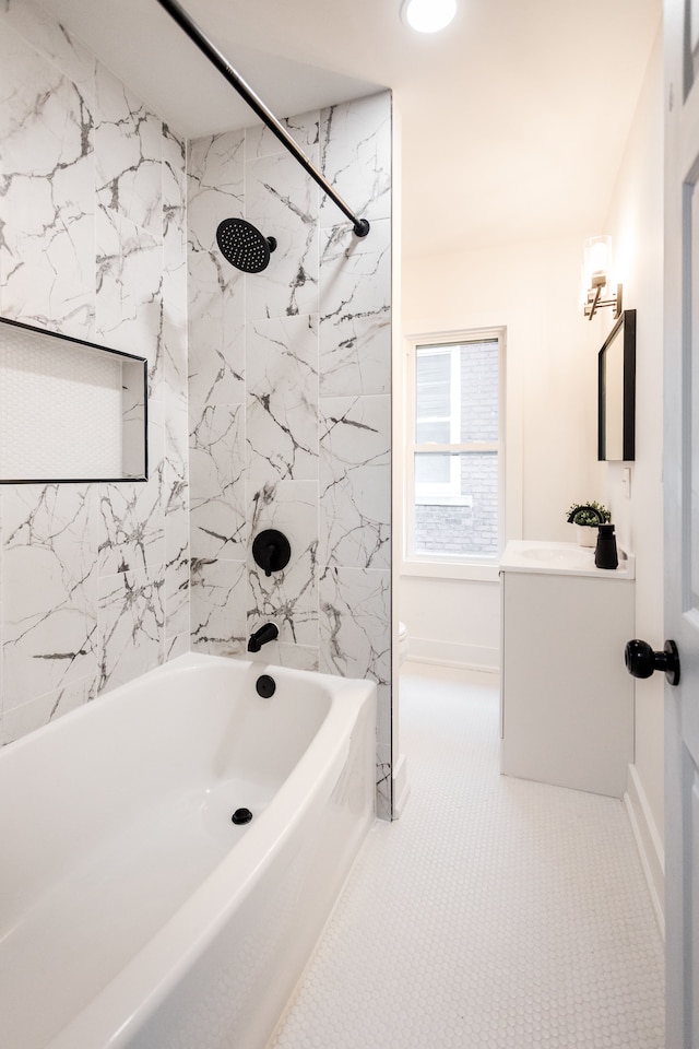 full bathroom featuring toilet, tile patterned floors, vanity, and tiled shower / bath combo