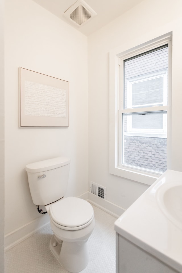 bathroom featuring tile patterned floors, toilet, and vanity