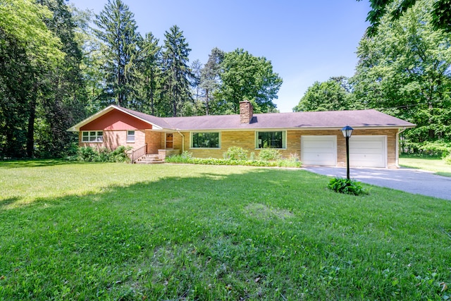 ranch-style house featuring a garage and a front yard