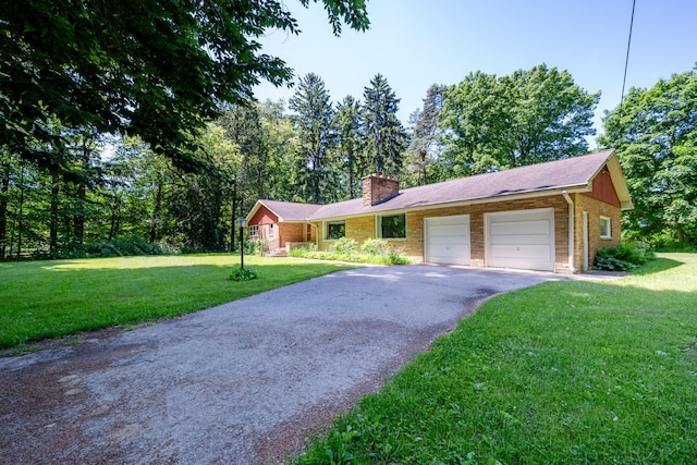 single story home featuring a front lawn and a garage