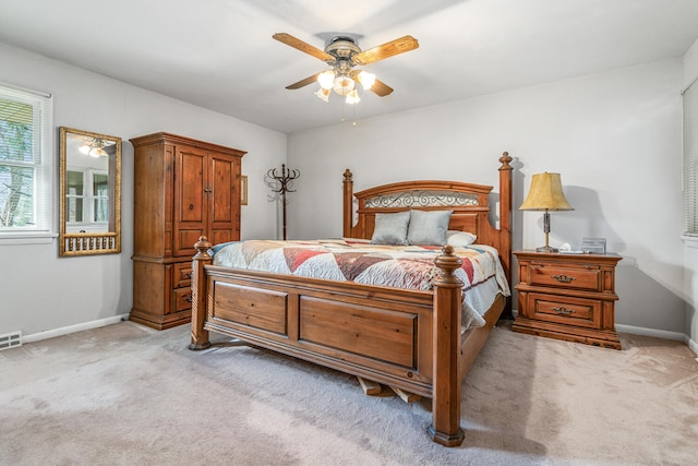 bedroom with light carpet and ceiling fan