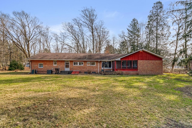 back of house with a yard and central AC unit