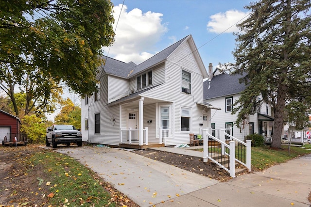 330 NE Page St, Grand Rapids, MI 49505 - view of front of house with a shingled roof and driveway