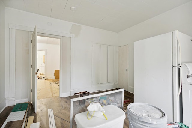 bathroom featuring wood-type flooring and crown molding