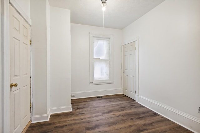 empty room featuring dark hardwood / wood-style flooring