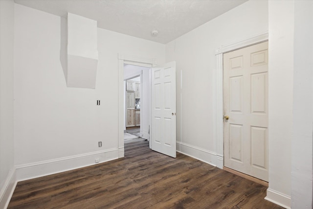 empty room with dark hardwood / wood-style floors