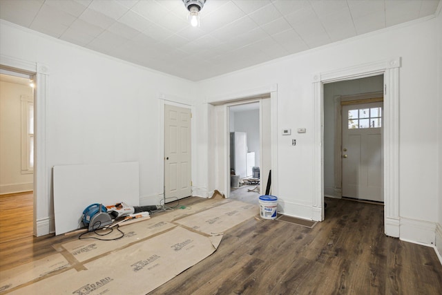 empty room featuring dark hardwood / wood-style floors and ornamental molding