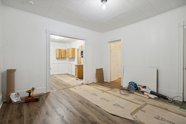 unfurnished bedroom with hardwood / wood-style floors and ornamental molding