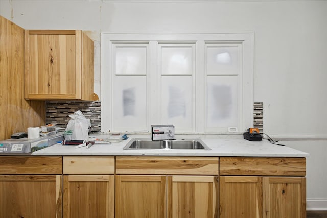 kitchen featuring backsplash and sink