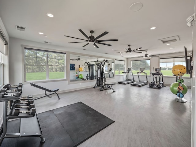 exercise room with ceiling fan and a wealth of natural light