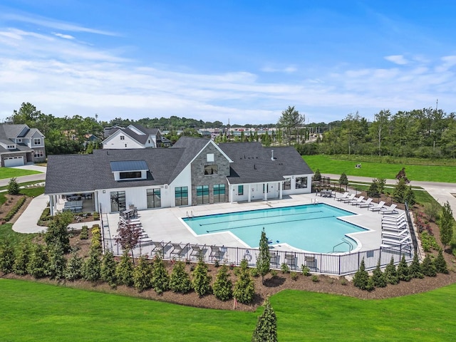 view of pool featuring a yard and a patio