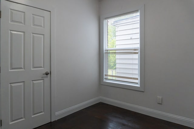 spare room with dark hardwood / wood-style floors