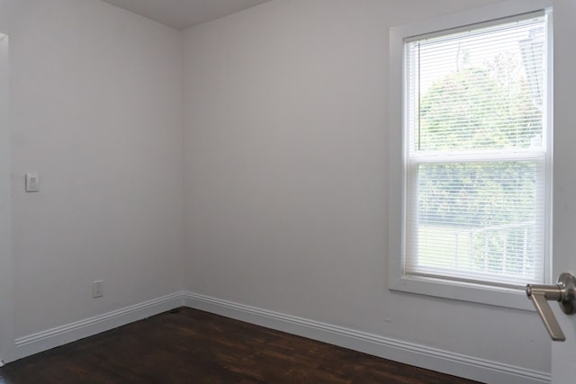 spare room with dark hardwood / wood-style floors