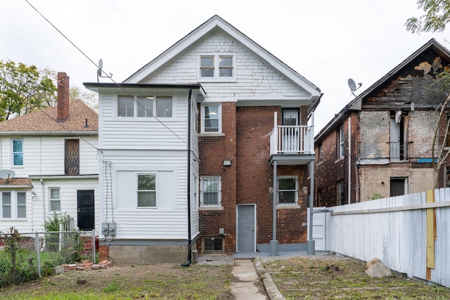 back of property featuring a balcony