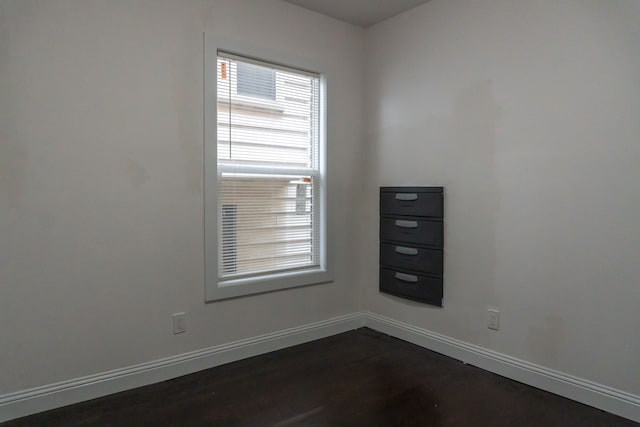 unfurnished room with dark hardwood / wood-style floors