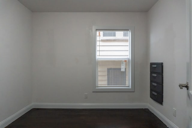 empty room with dark hardwood / wood-style floors