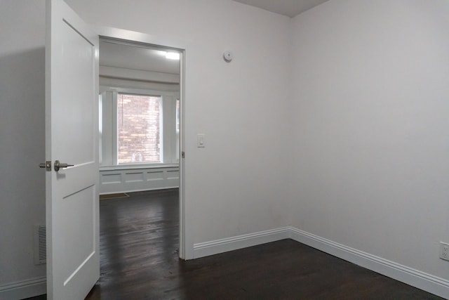 empty room featuring dark wood-type flooring