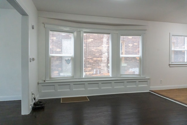 unfurnished room with dark hardwood / wood-style flooring