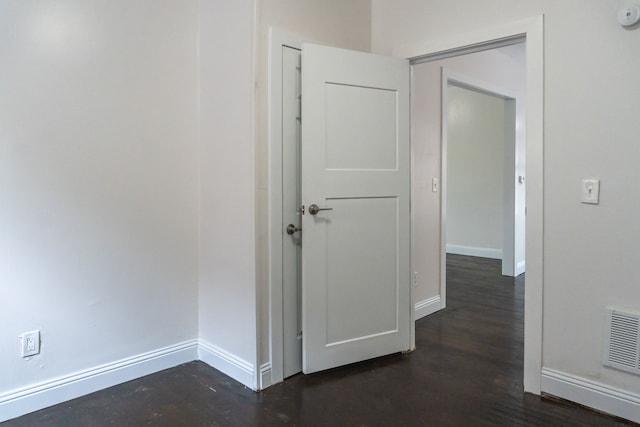 corridor with dark hardwood / wood-style floors