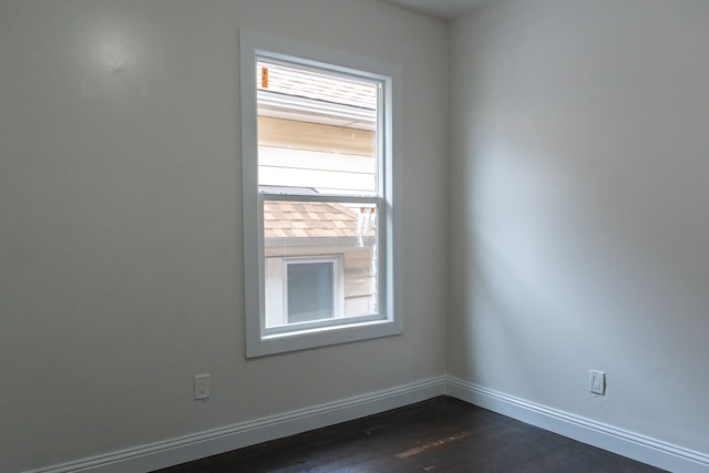 empty room with dark hardwood / wood-style flooring