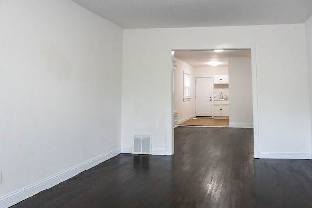 spare room with dark hardwood / wood-style floors