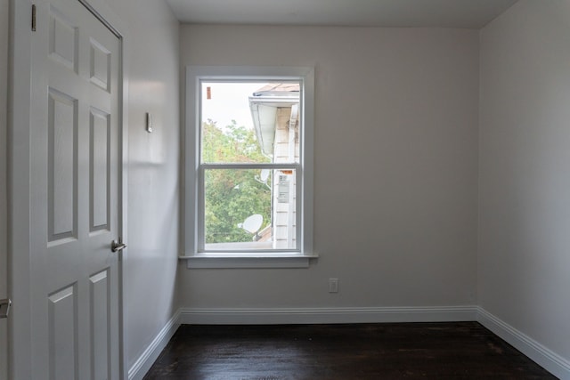 unfurnished room with dark hardwood / wood-style floors