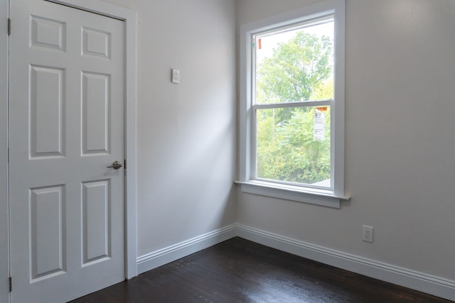 unfurnished room featuring dark wood-type flooring